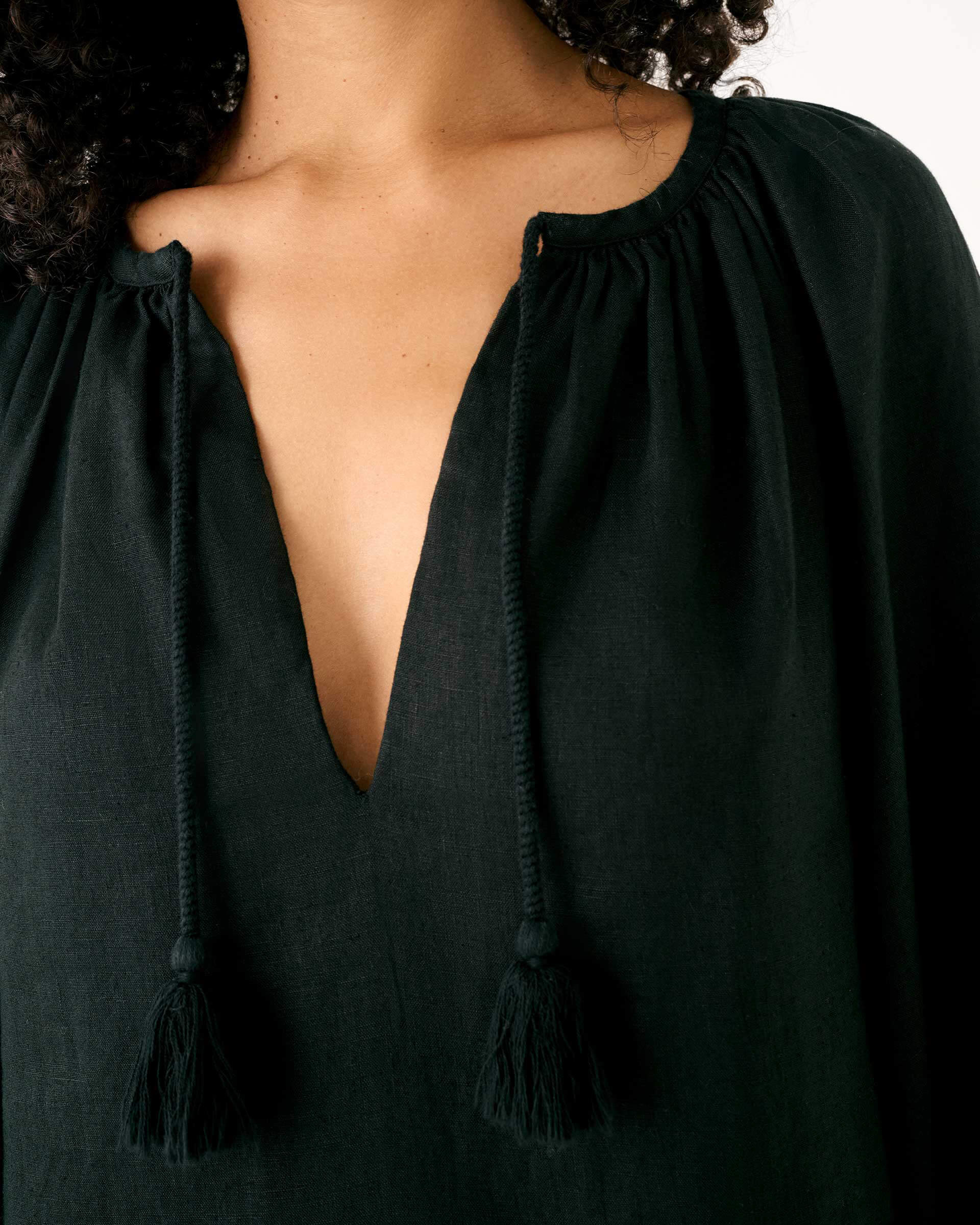 Women's Black Summer Lightweight Relaxed Fit Tea Length Fete Linen Dress with V-neck Tassel Ties and Pintuck Cuffs Closeup Neckline