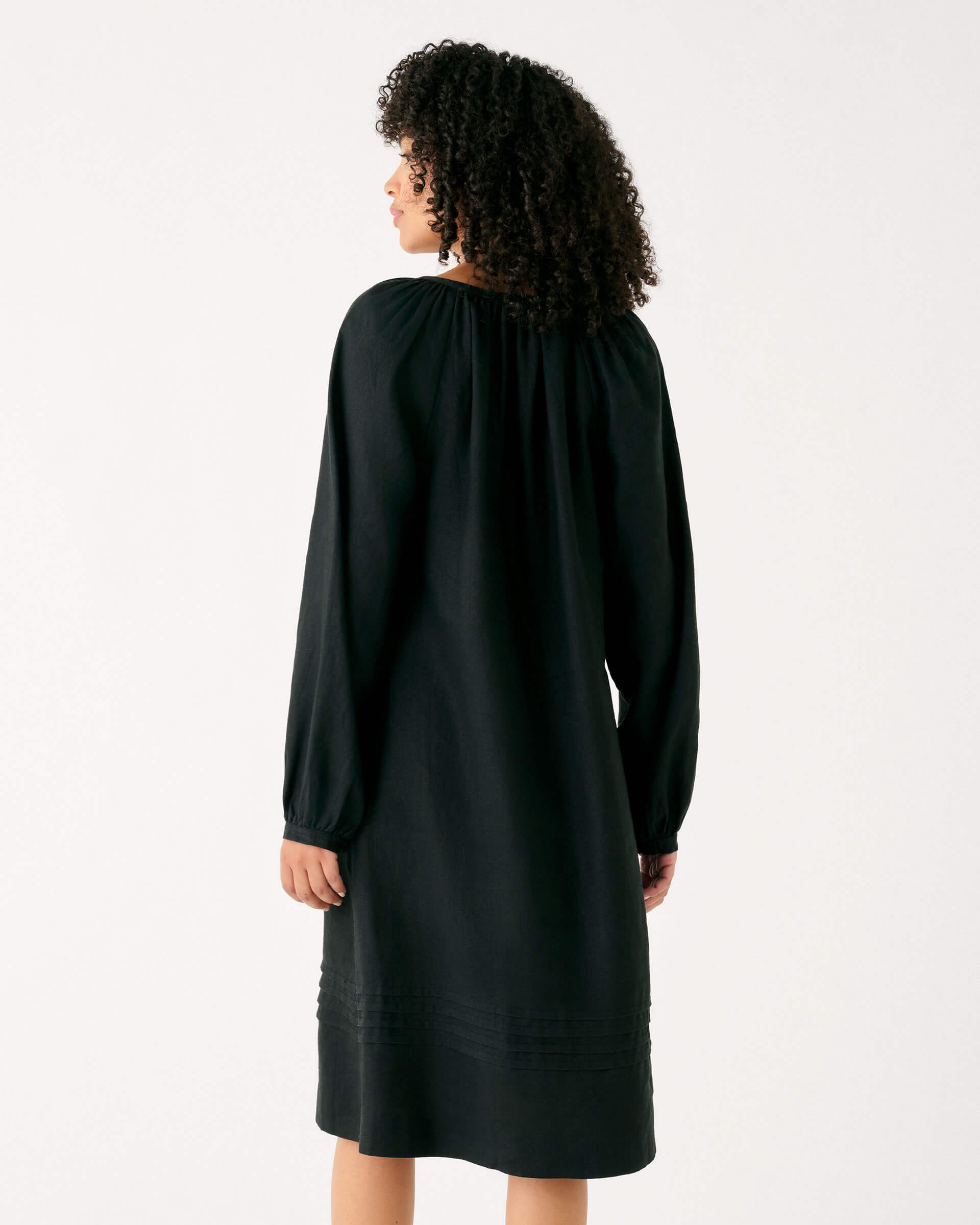 Women's Black Summer Lightweight Relaxed Fit Tea Length Fete Linen Dress with V-neck Tassel Ties and Pintuck Cuffs Rear View
